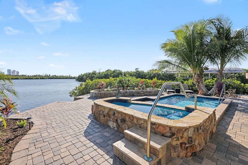 Immaculate bay front home w/in ground pool, spa, paver patio & porch