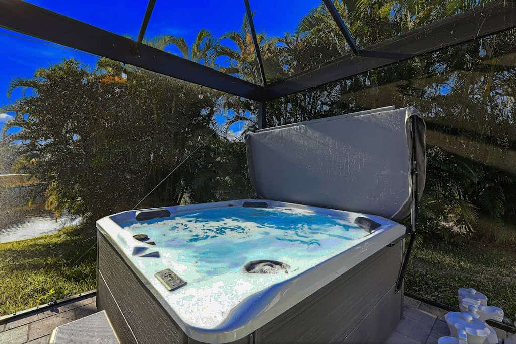 Canal front home with saltwater pool, hot tub, and washer and dryer.