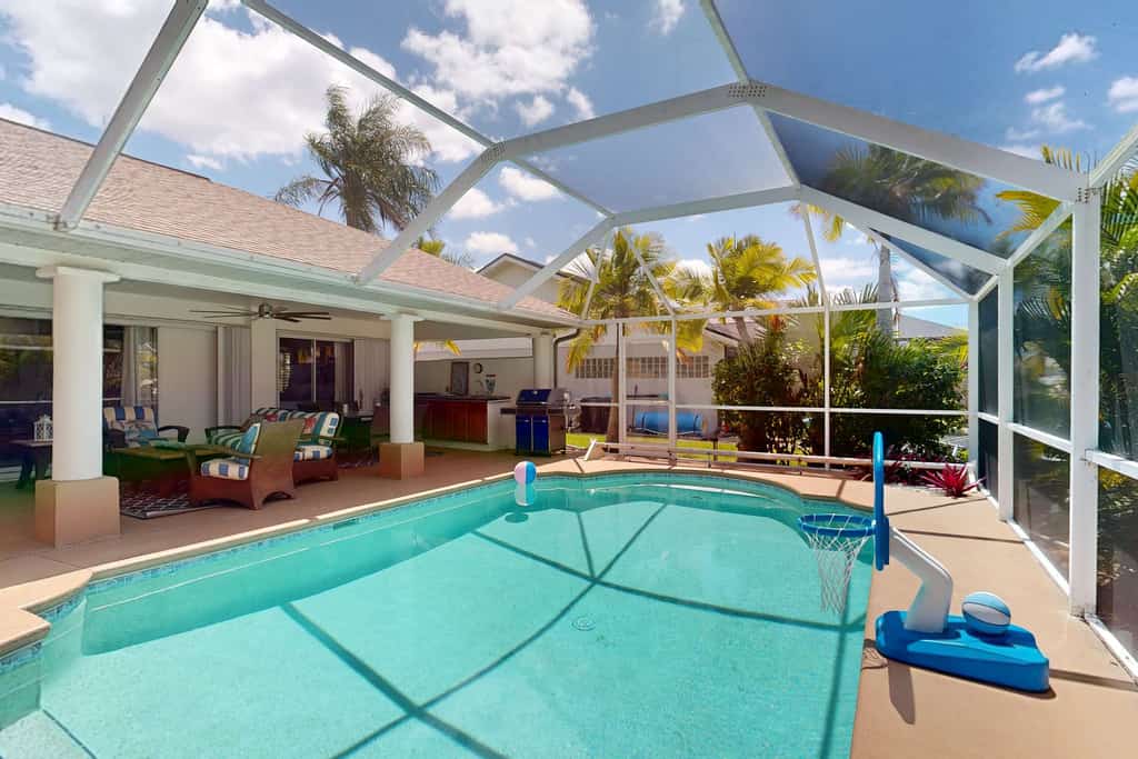 Waterfront home with private, heated pool, dock, and lanai