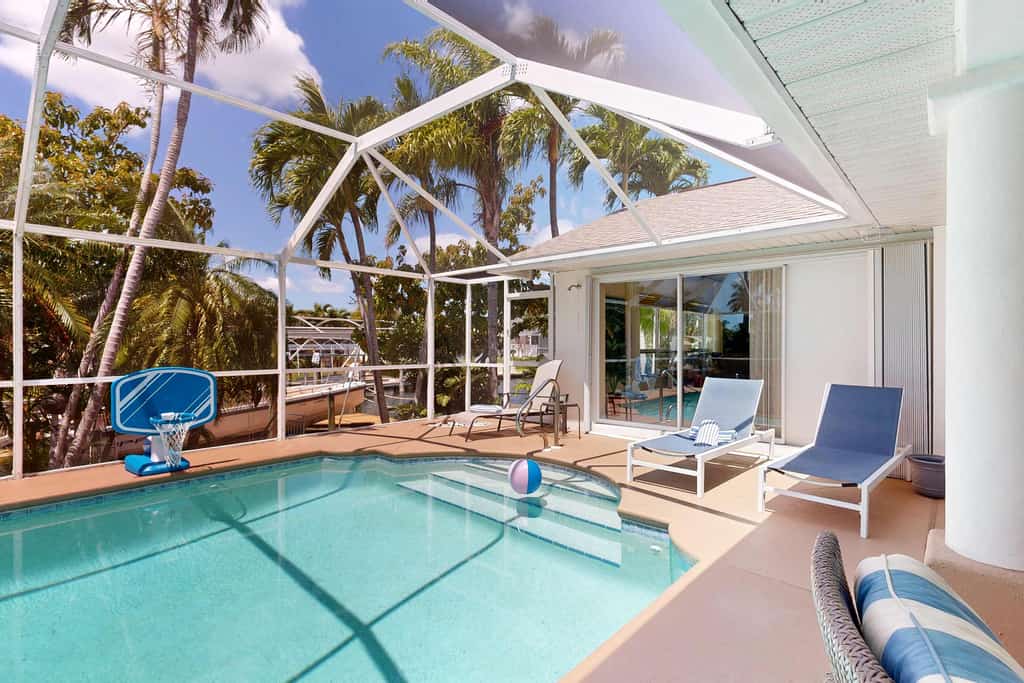 Waterfront home with private, heated pool, dock, and lanai