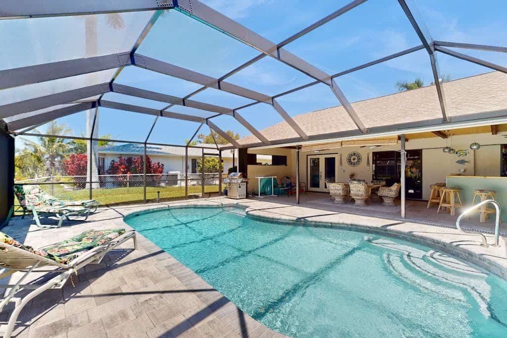 Coastal Cabana - canal-front home with private heated pool, dock, inviting patio