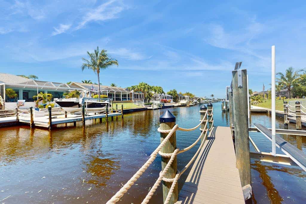 Coastal Cabana - canal-front home with private heated pool, dock, inviting patio