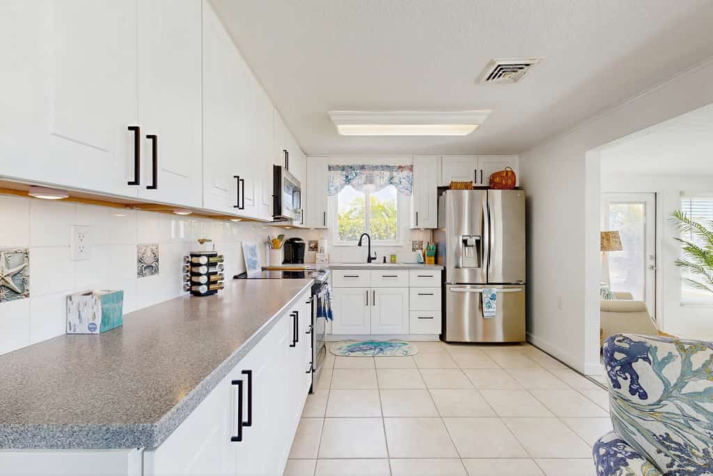 Waterfront home with canal access, patio, sun room, & central AC - near beach