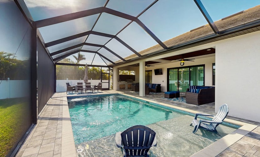 Modern canal-front luxury with pool, patio, grill, dock, Ping-Pong, AC, & WiFi