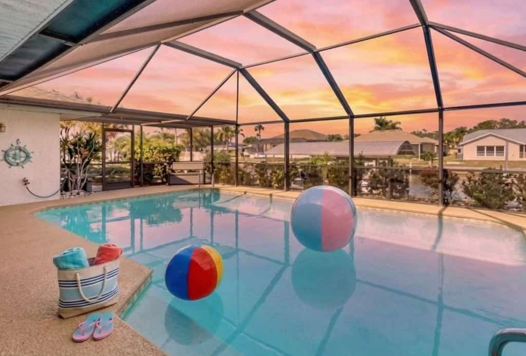 Waterfront home with saltwater pool, spacious outdoor area, and dock