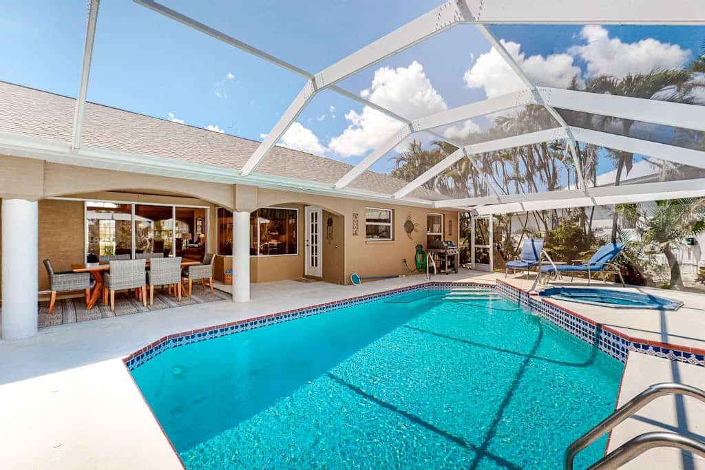 Canal-front home with private heated pool, pool spa, dock, kayaks, grill, 1 bike
