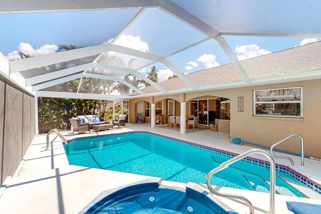 Canal-front home with private heated pool, pool spa, dock, kayaks, grill, 1 bike