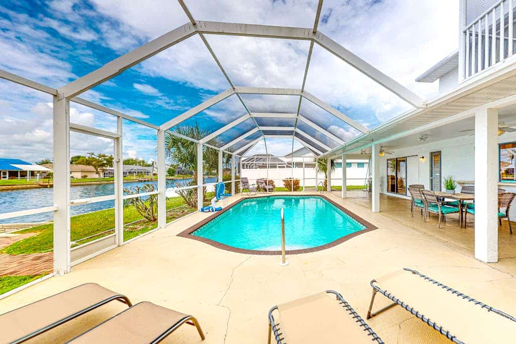 Water-view home with enclosed private pool, grill, scenic balcony, AC & W/D