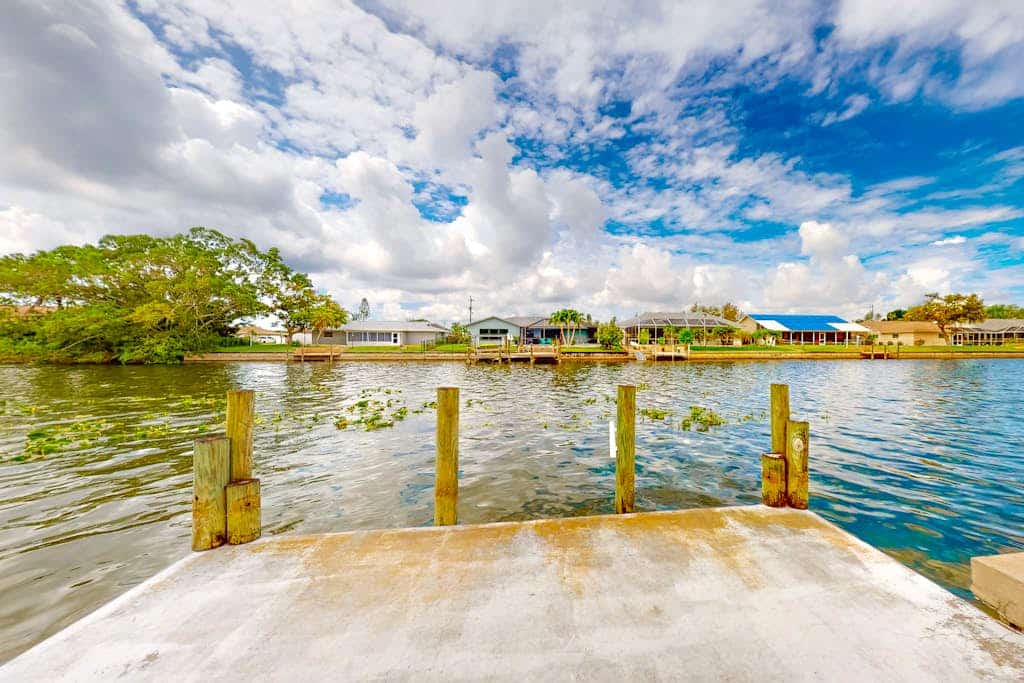 Water-view home with enclosed private pool, grill, scenic balcony, AC & W/D