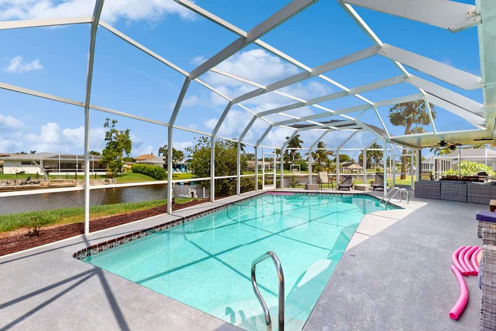 Waterfront home with heated pool, dock, & kayaks - minutes to beach