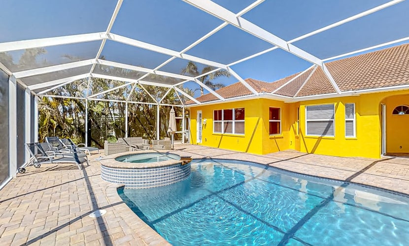 Canal-front home with pool, outdoor kitchen, & private dock - dog-friendly
