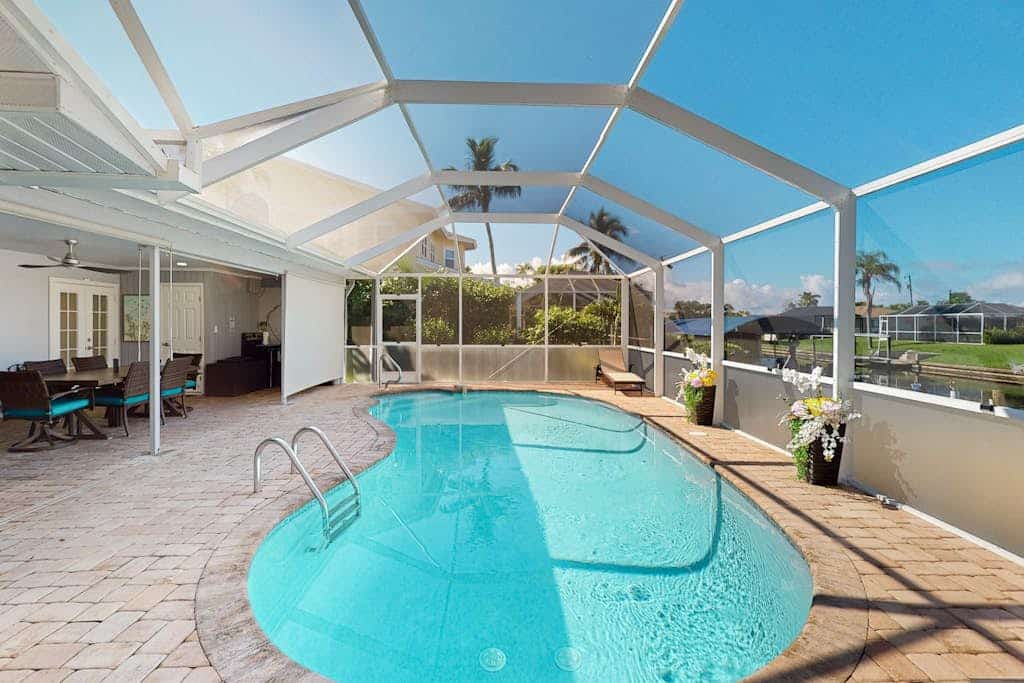 Canal-front home with private heated pool, dock, river views, patio, grill & W/D