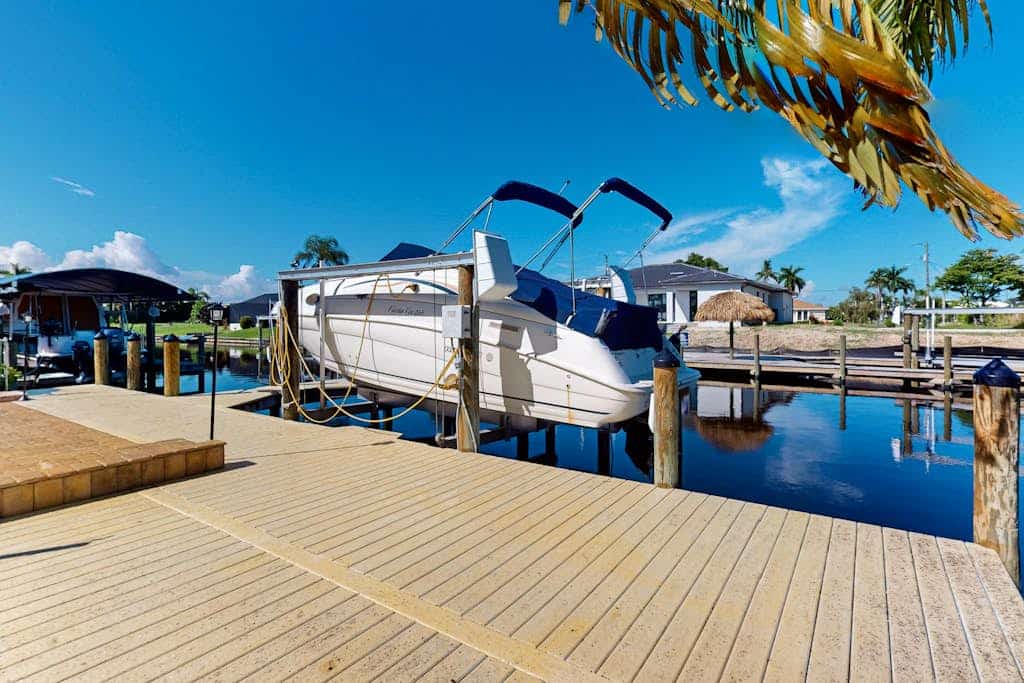 Canal-front home with private heated pool, dock, river views, patio, grill & W/D