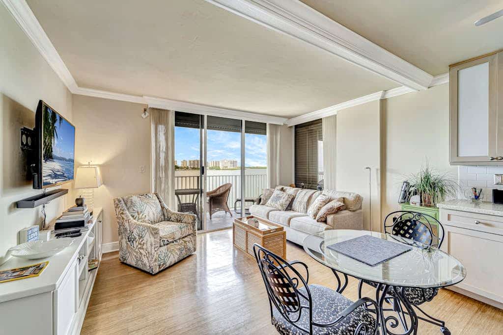 Waterfront condo with private beach area, pool, hot tub, grills, & balcony