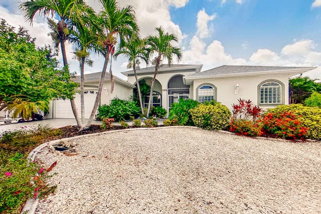Dog-friendly waterfront home with heated pool, lanai, central AC, & W/D