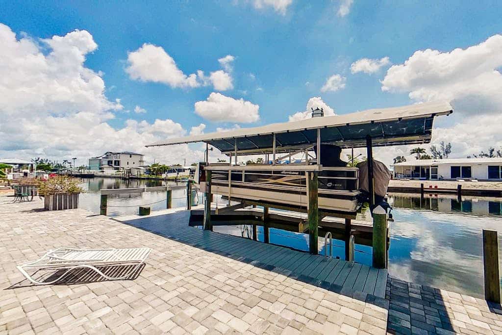 Dog-friendly waterfront home with heated pool, lanai, central AC, & W/D