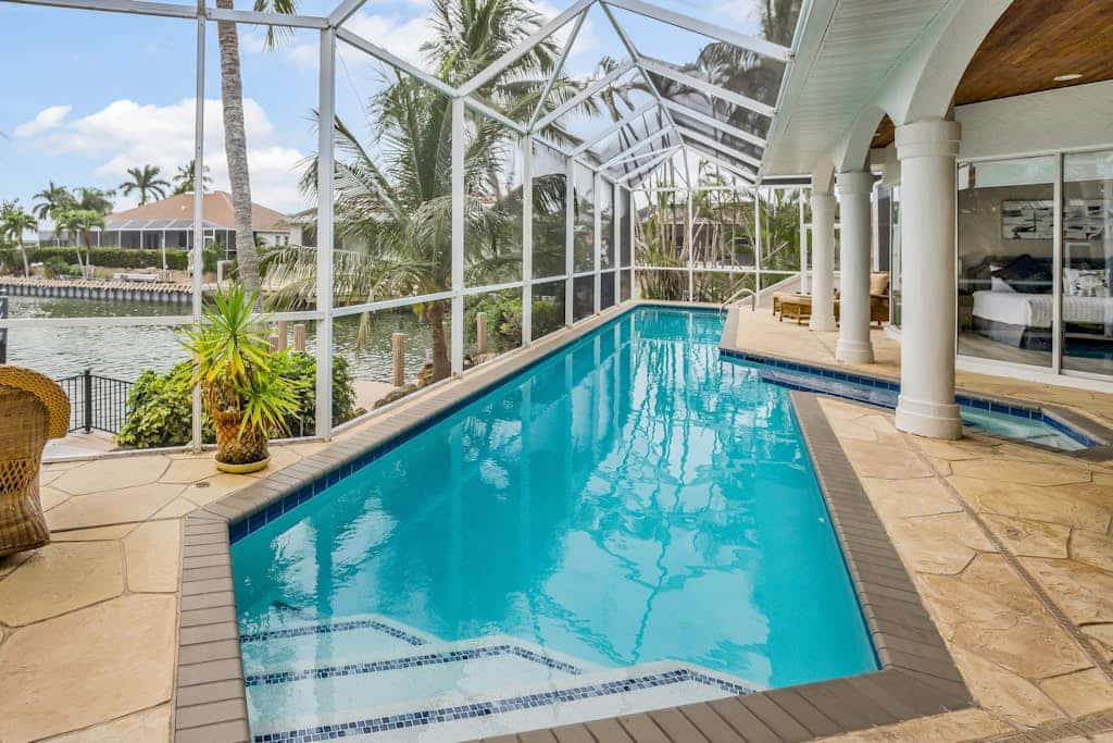 Luxury canal home with pool, alfresco dining, & walk-in shower - walk to beach