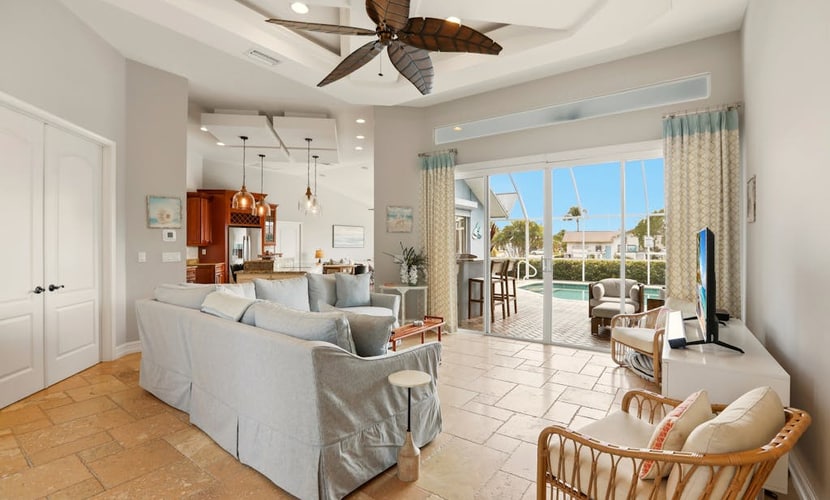 Large corner lot home with canal views & screened in pool - close to the beach