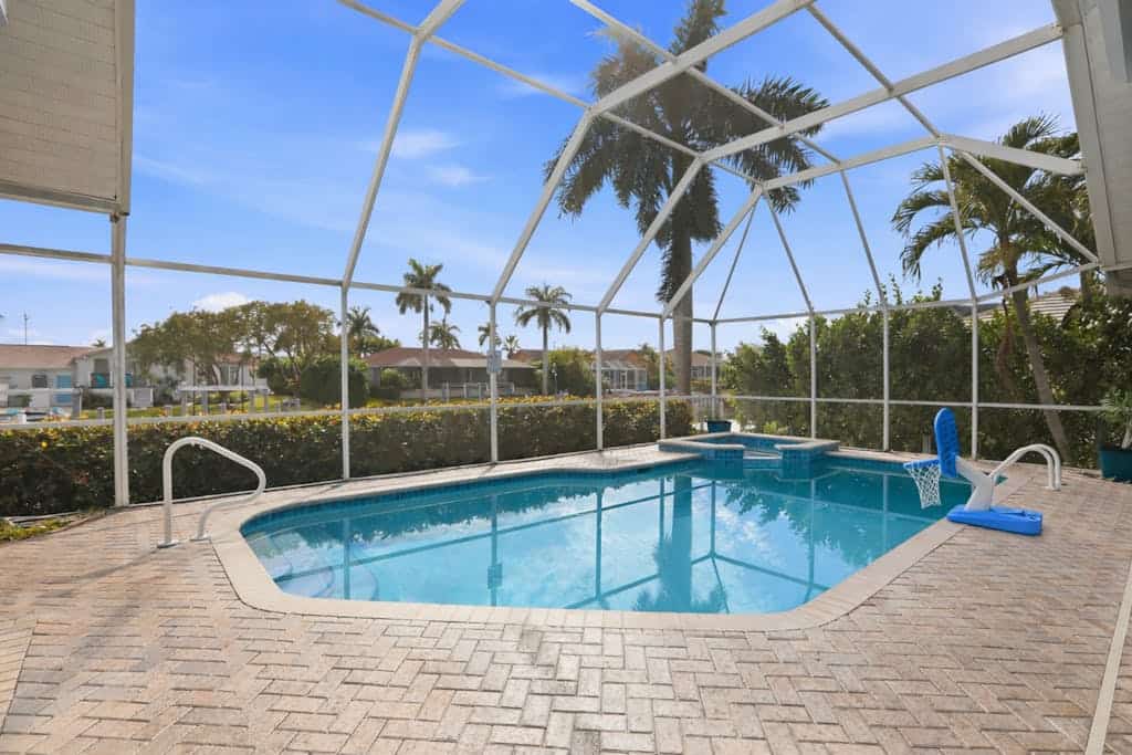 Large corner lot home with canal views & screened in pool - close to the beach