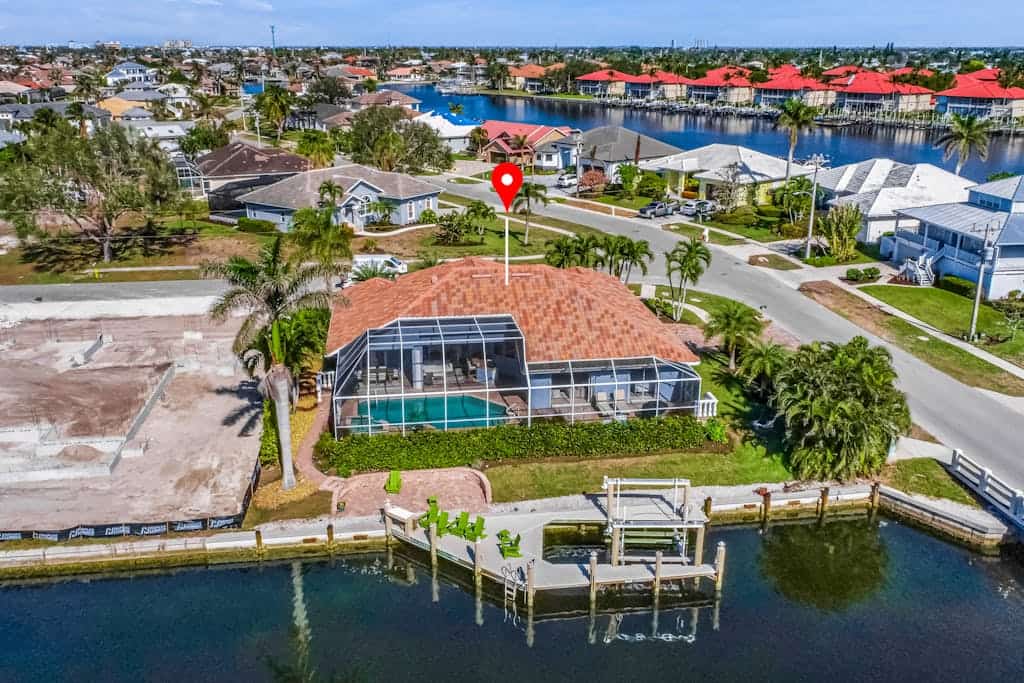 Large corner lot home with canal views & screened in pool - close to the beach