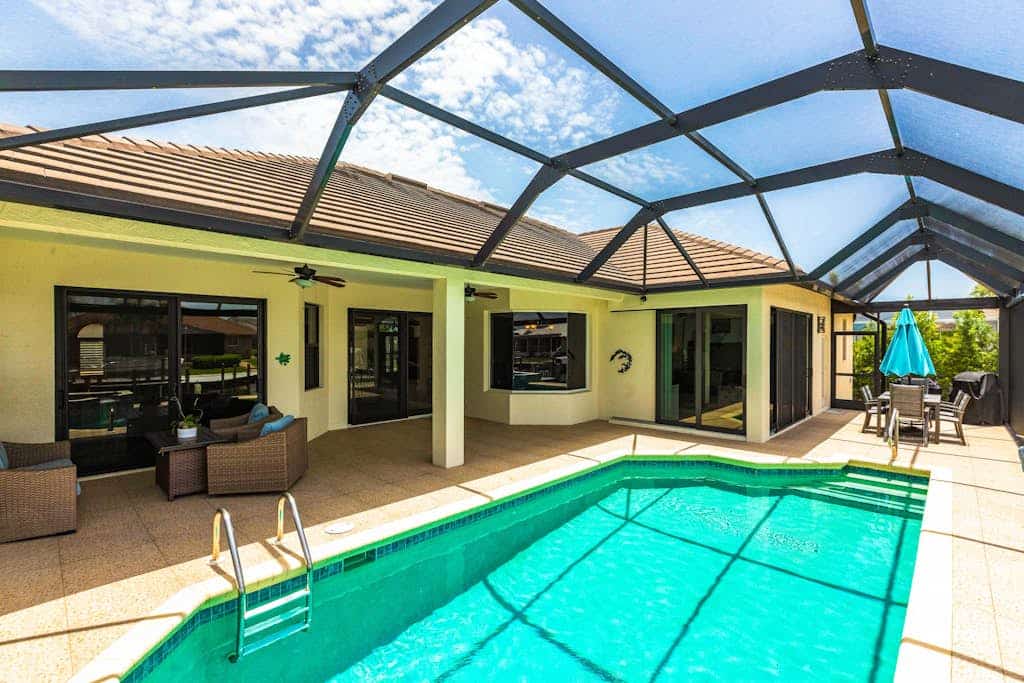 Modern waterfront retreat has pool with spa waterfall, close to Gulf beaches