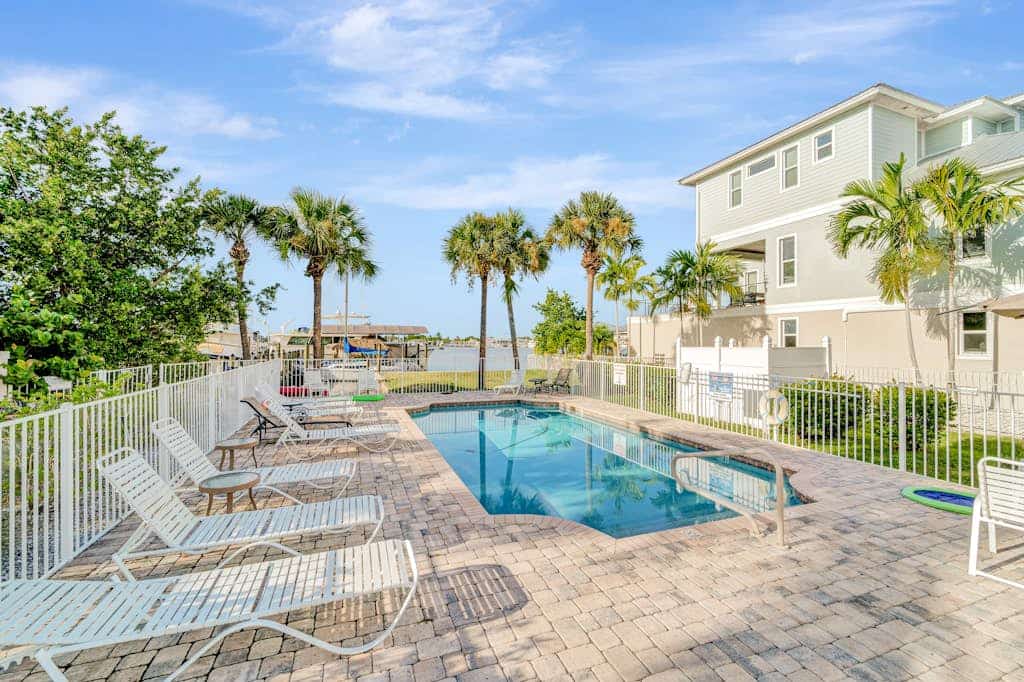 Water-view villa with sunset balconies, grill, & pool - walk to beach and dining