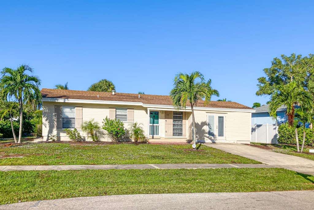 Updated tropical home with a private patio, beach gear, AC, and washer/dryer
