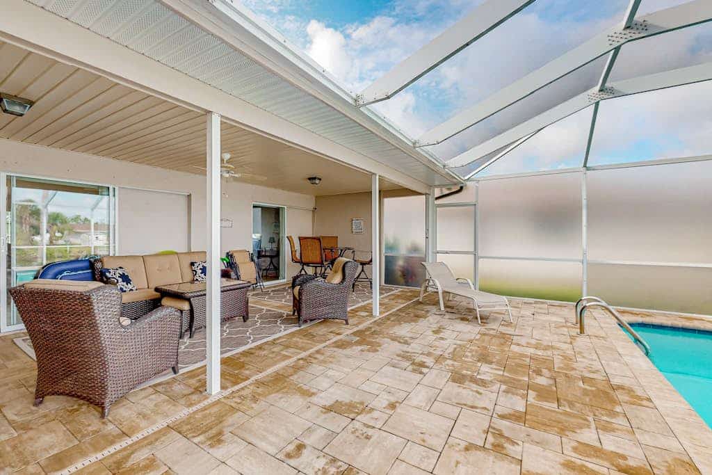 Waterfront home with an enclosed pool, outdoor kitchen, and grill - dog-friendly