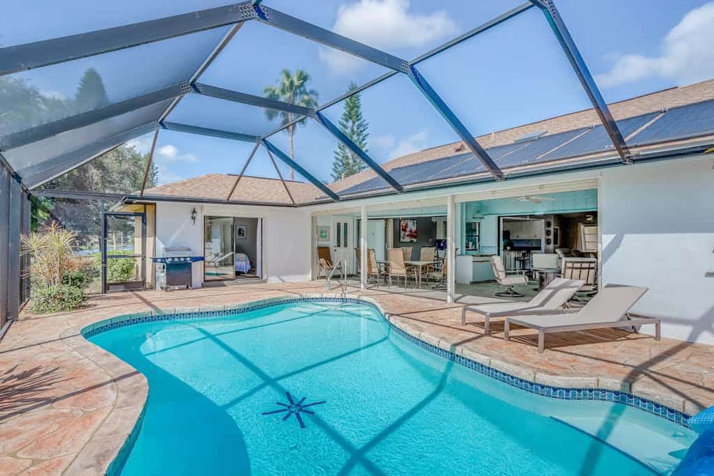 Canal-front home with sandy beaches, golf courses, dock, & refreshing pool
