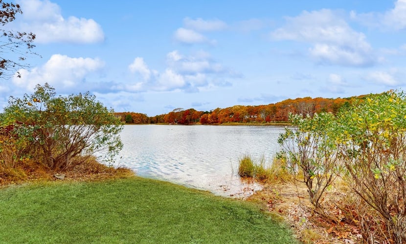 Waterfront Cape house with large deck, fireplace, modern kitchen & grassy yard