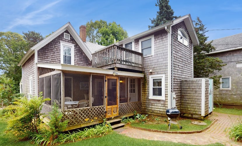 Inviting, two-story home with a large yard, sunroom, balcony, & washer/dryer