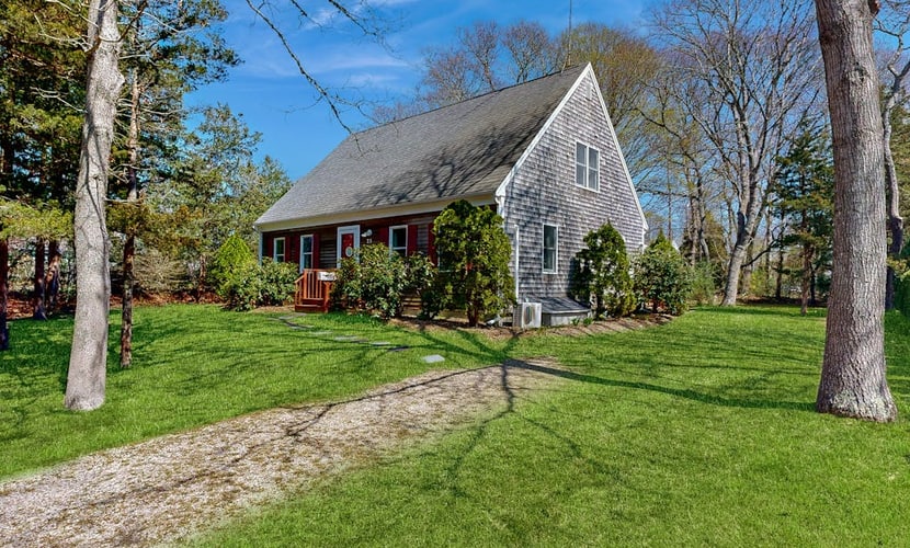 2-story home near the beach with large lawn, deck, W/D, streaming, & partial AC