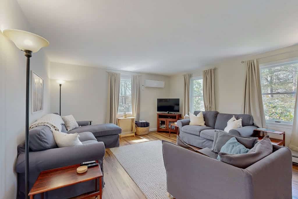2-story home near the beach with large lawn, deck, W/D, streaming, & partial AC