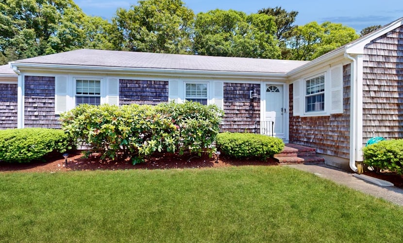 Charming coastal home near pond with sunroom, open layout, yard & AC