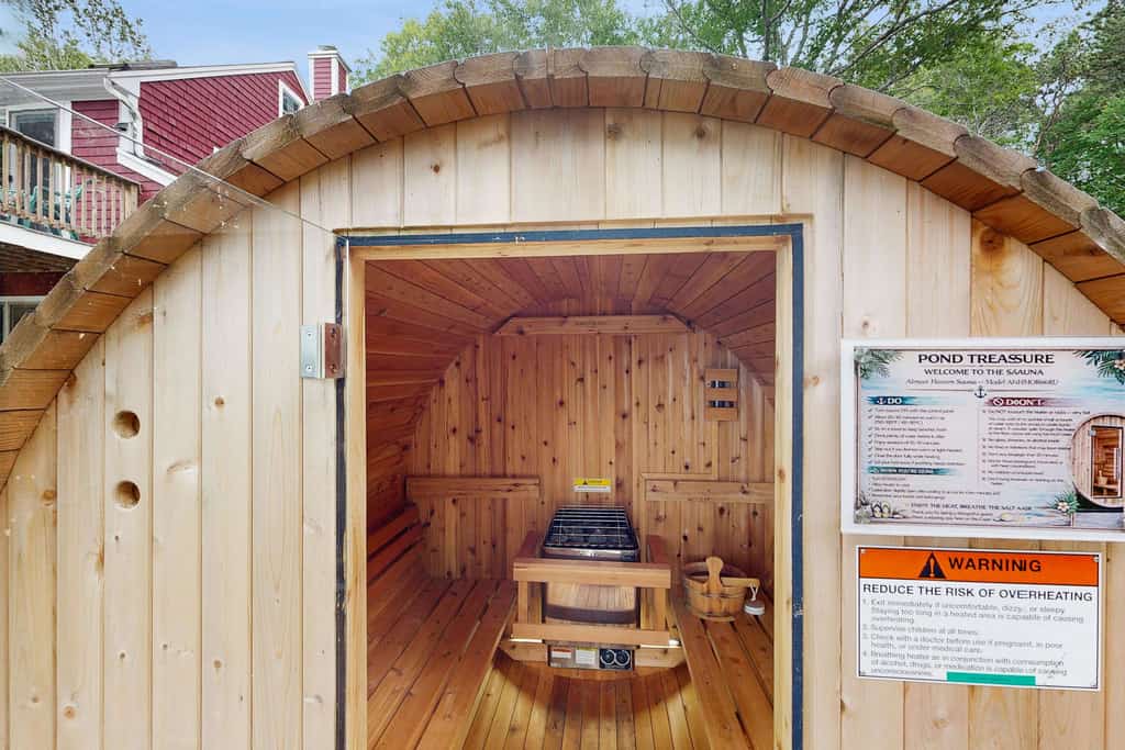 Pondfront escape with private beach, hot tub, sauna, play area & dog-friendly