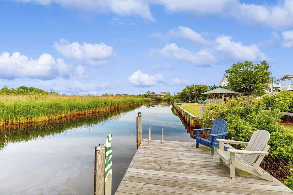 Bayfront home with great views, pool, hot tub, deck, sunroom, & dock - dogs OK