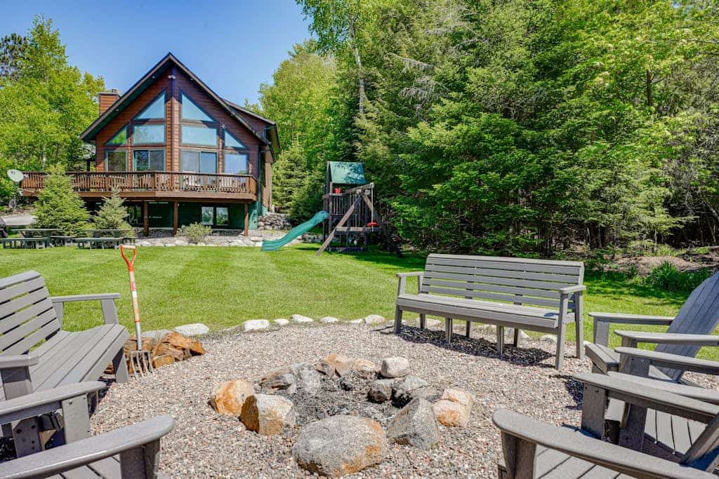 Lakefront lodge with private dock, firepit, deck & sunset views