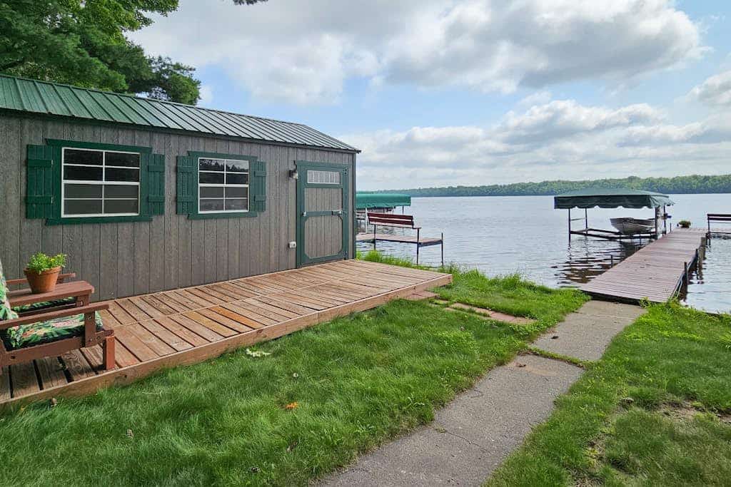 Waterfront home between 2 lakes w/ heated porch, dock & kayaks