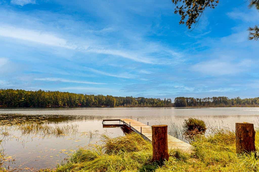 Lakefront, dog-friendly home with canoe, firepit, large deck, & washer/dryer