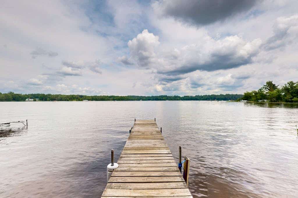 Lakefront cottage w/ a dock, shared furnished patio, firepit, & a paddleboat