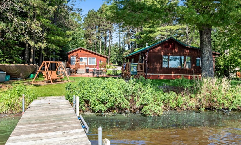 Two cozy, lakefront cottages w/ 2 docks, a patio, firepit, 2 gas grills, & WIFI