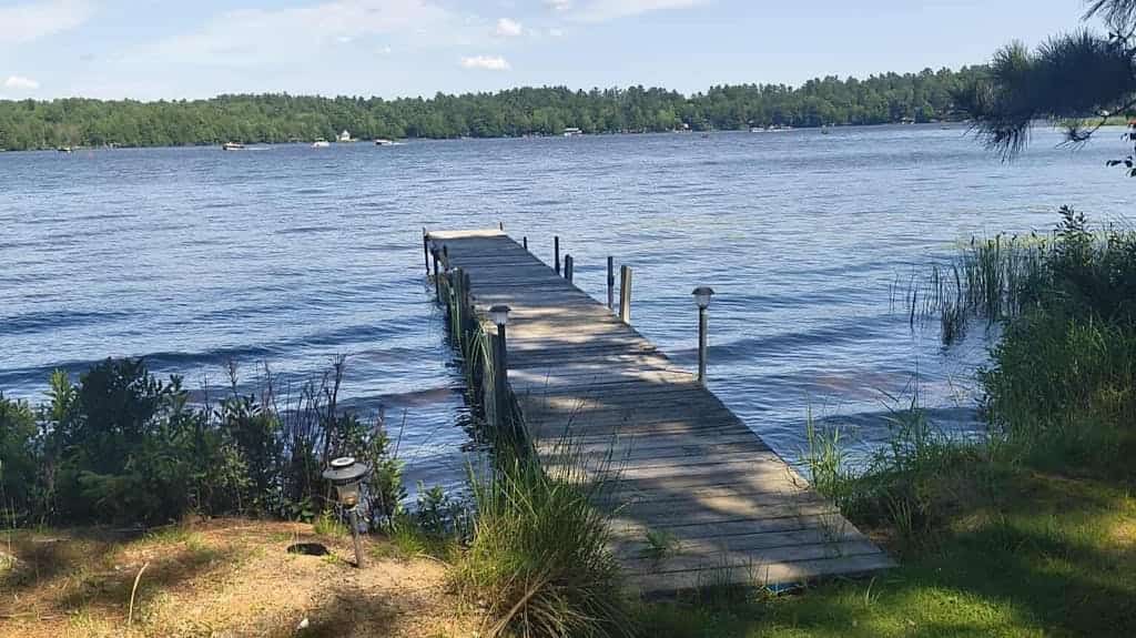 Two cozy, lakefront cottages w/ 2 docks, a patio, firepit, 2 gas grills, & WIFI