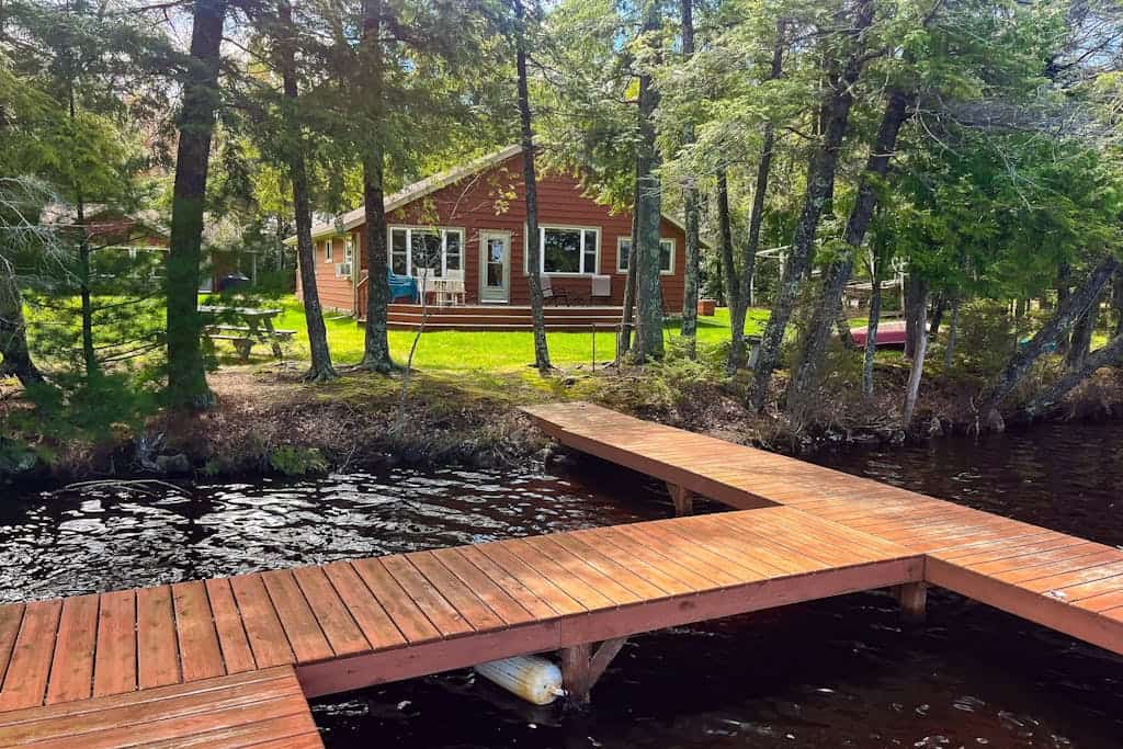 Dog-friendly lakefront property with dock, boat lift, firepit, & hot tub