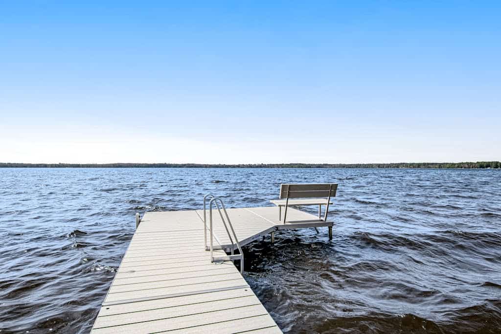 Dog-friendly, lakefront house with beach access, dock, AC, W/D, patio, & firepit
