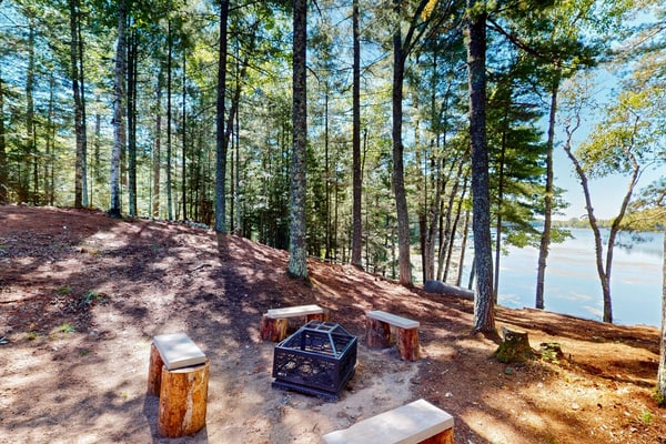 Dog-friendly, lakefront getaway with a firepit, dock, washer/dryer, & AC