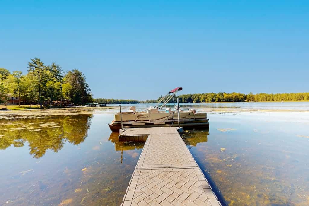 Dog-friendly, lakefront getaway with a firepit, dock, washer/dryer, & AC