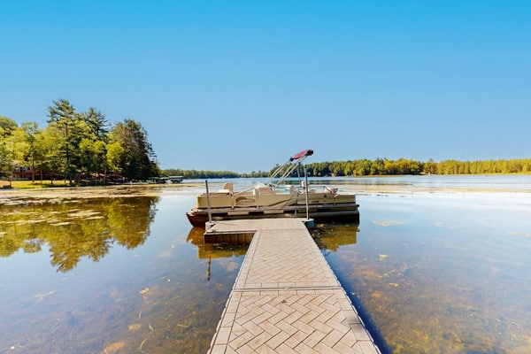 Dog-friendly, lakefront getaway with a firepit, dock, washer/dryer, & AC