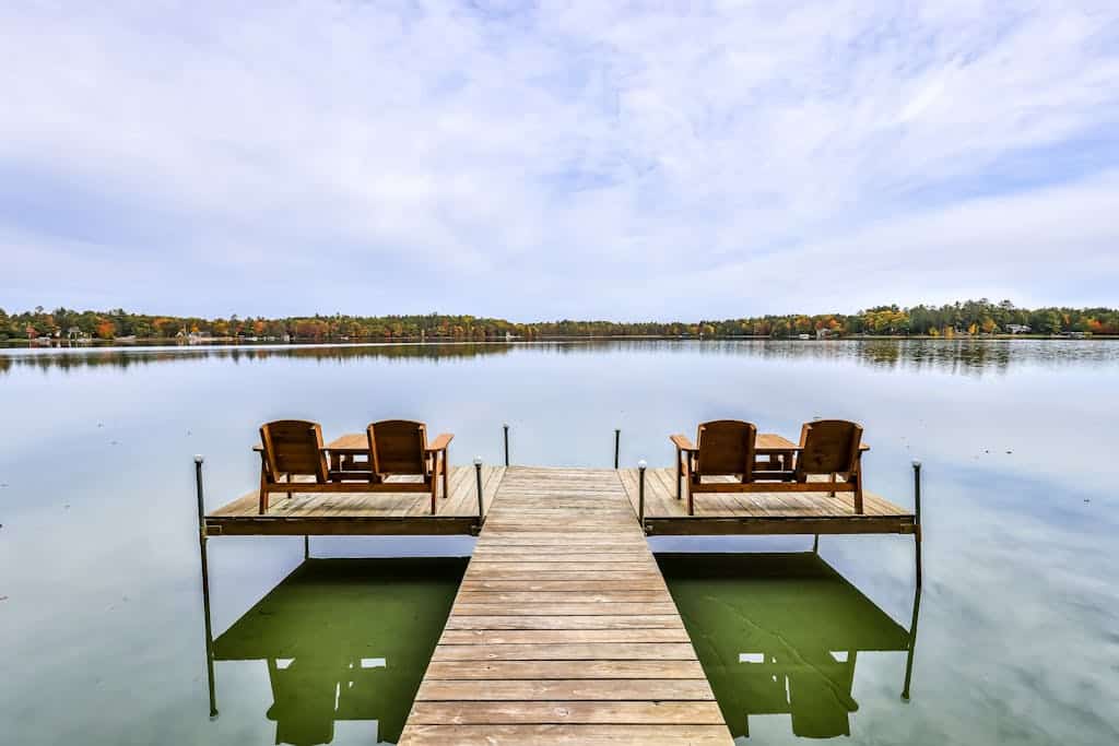 Lakefront home with private dock, screened porch, woodstove, fast WiFi, & W/D