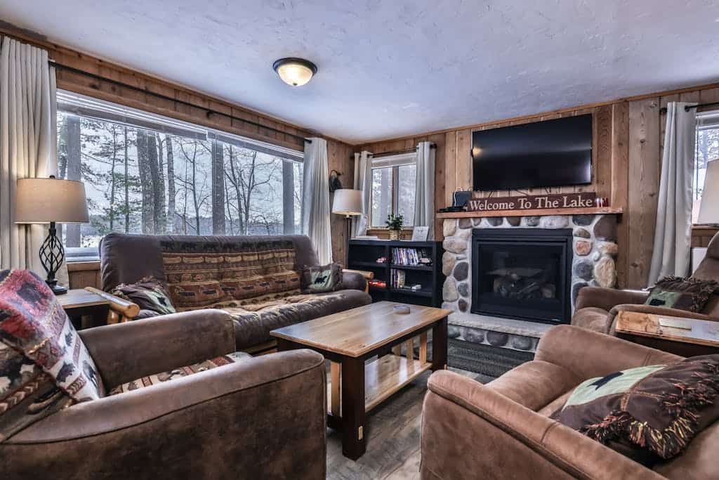 Snowy lake-view cabin with fireplace, full kitchen, TV, dock, & DVD player