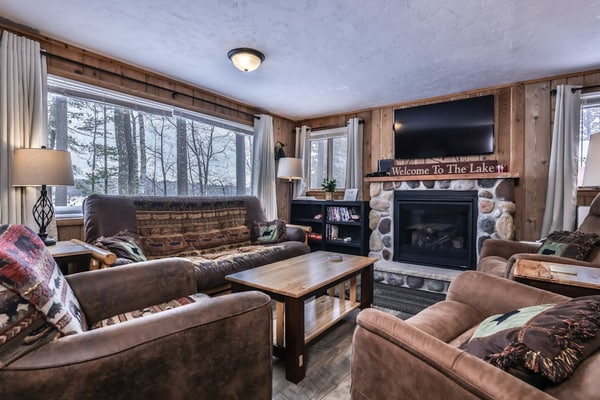 Snowy lake-view cabin with fireplace, full kitchen, TV, dock, & DVD player